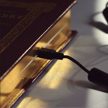 A cable plugged into a book.