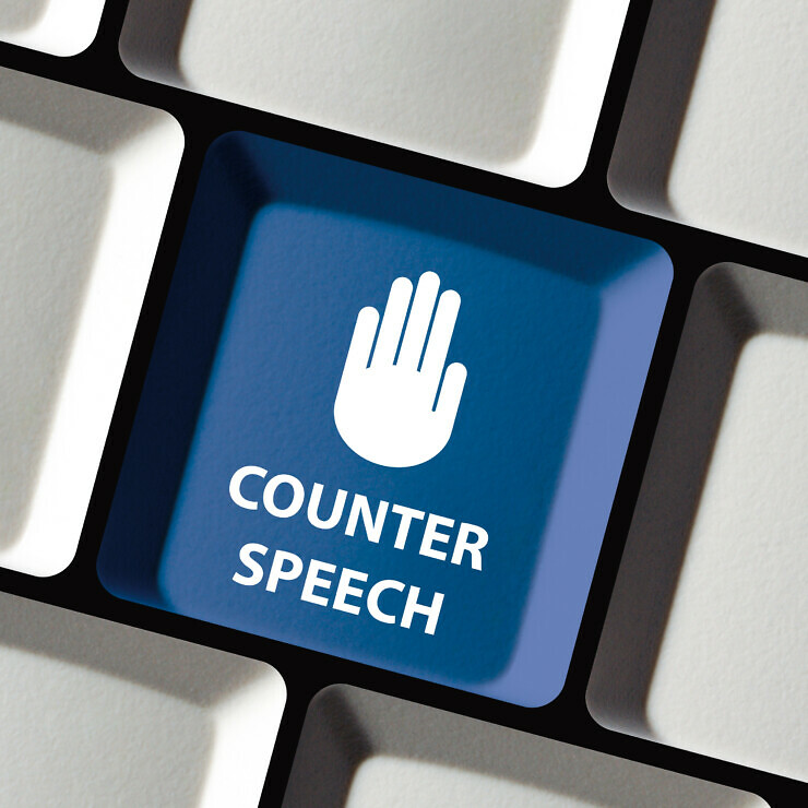 A keyboard key with a raised hand and the words 'Counter Speech'.