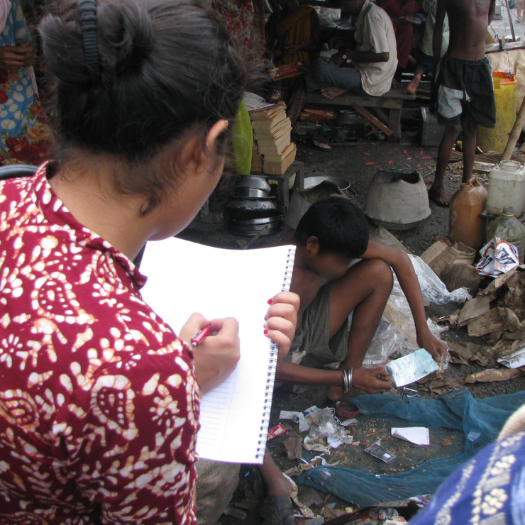 A researcher takes notes on fieldwork.