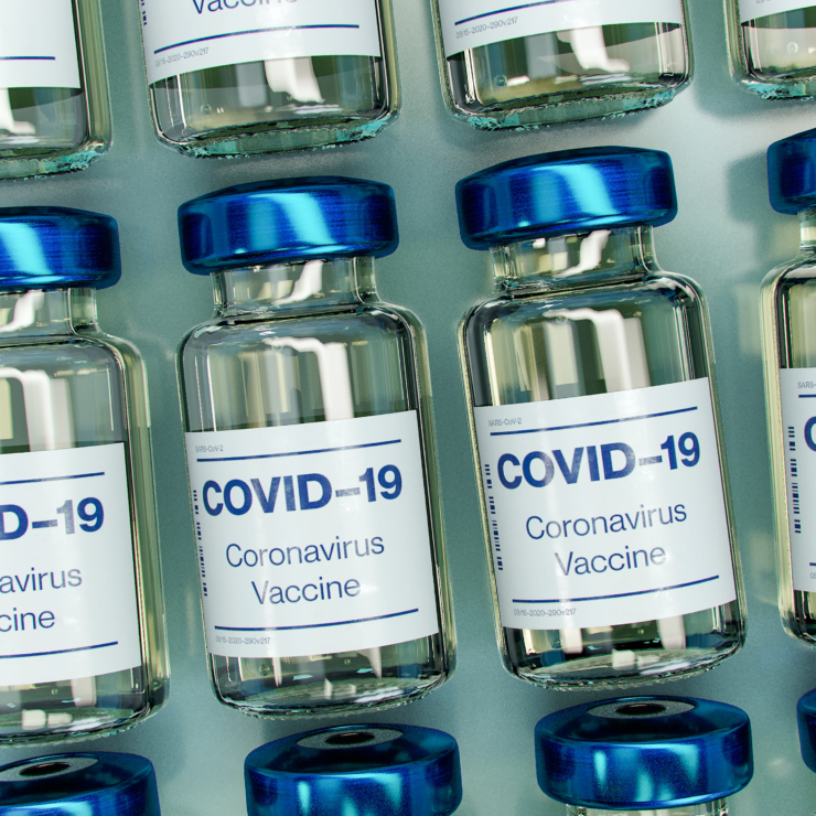 Covid-19 vaccine bottle arranged in decorative pattern