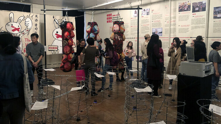 #MeToo in China exhibition with installation and visitors.