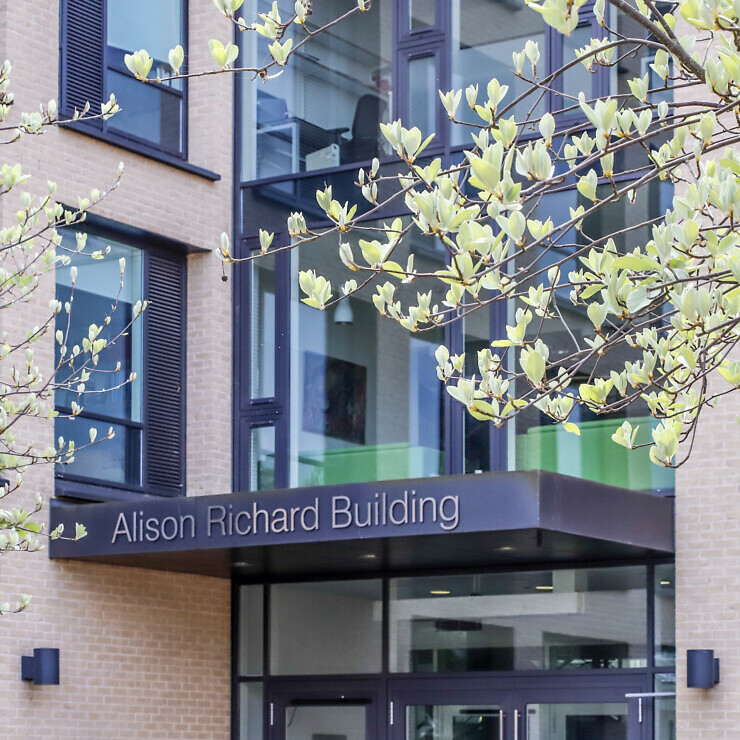 The Alison Richard Building front elevation with trees in Spring.