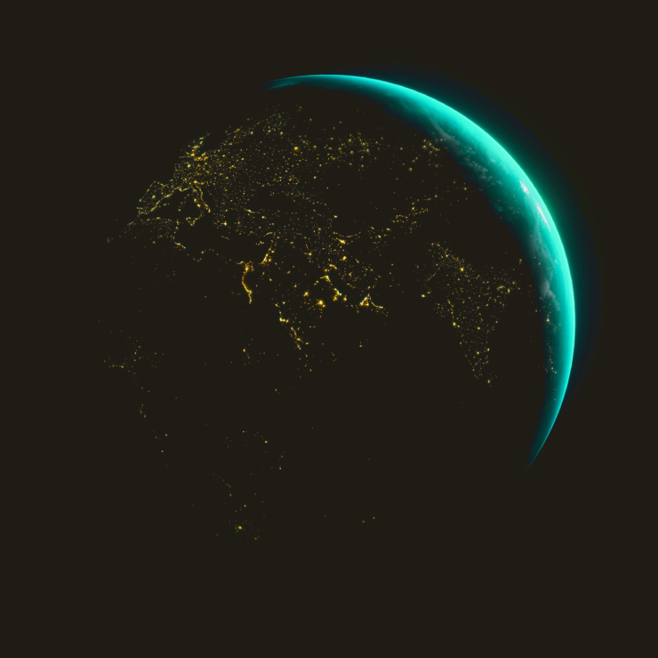 The earth seen from space. Earth's silhouette is visible in the darkness, as are cities that are lit up