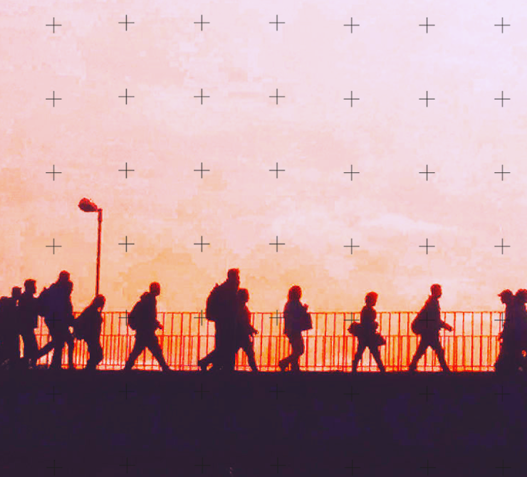 A line of people walking at sunset