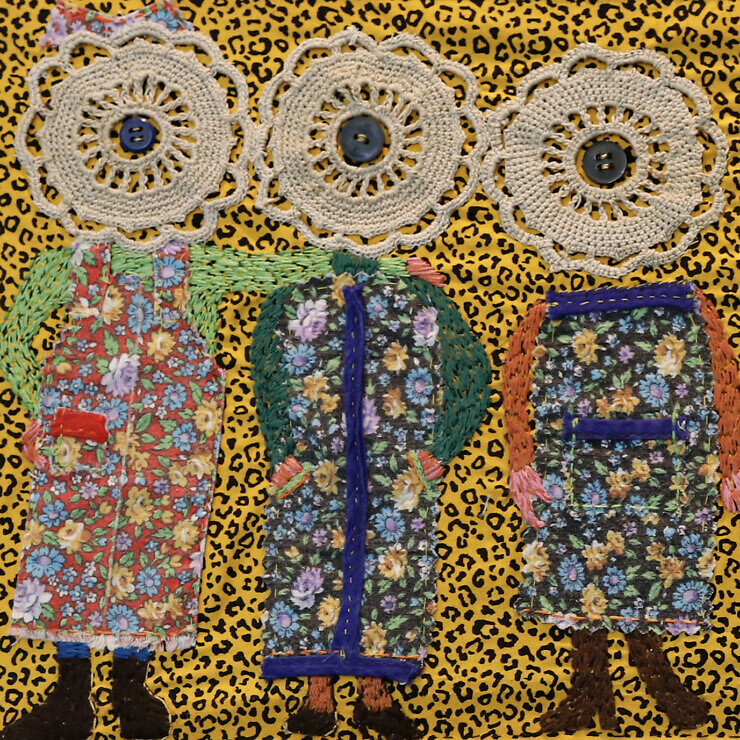 Textile femmage of a row of characters with flowery aprons and doilies for heads.