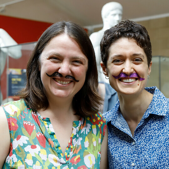 Event convenors with painted on moustaches