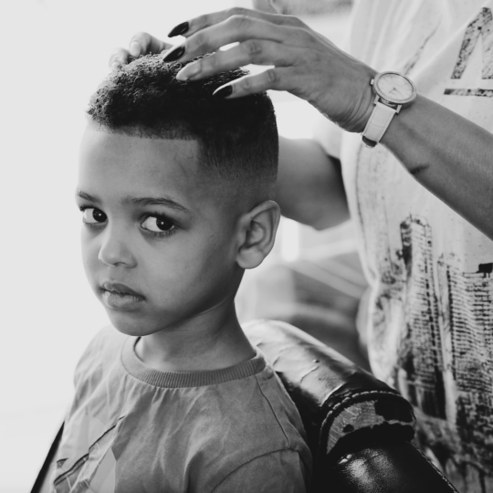 Black child having his hair cut