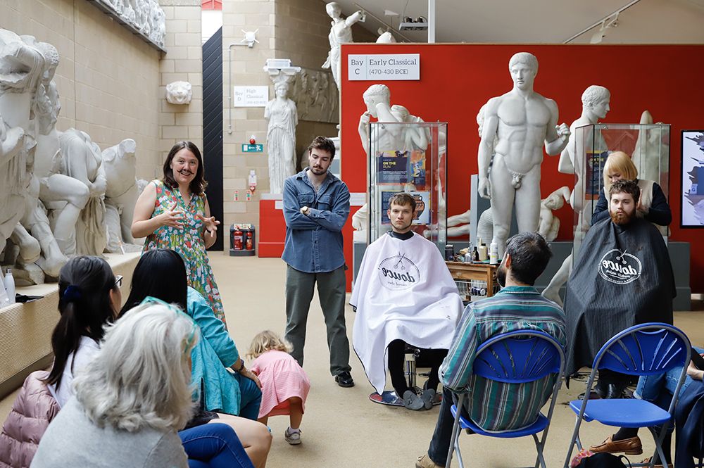 Barbers creating Roman haircuts at an event at the Faculty of Classics.