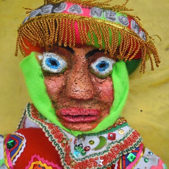 Indigenous puppet in colourful traditional dress.