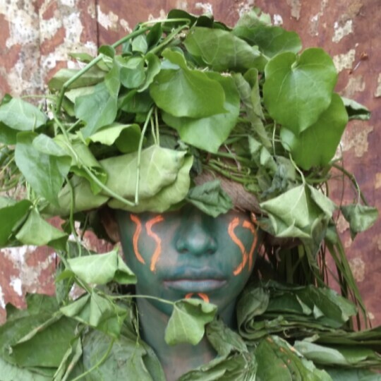 Image of an Amazon tribal person with leaves over their face